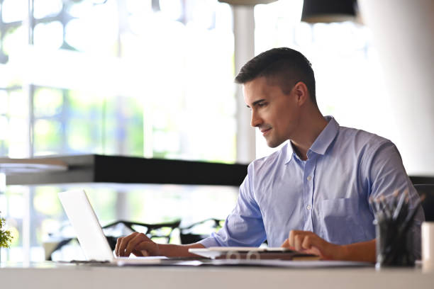 istock Confident businessman checking email with laptop computer at his office room. 1351410998
