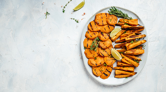 Roasted sweet potatoes with rosemary and lime. banner, menu, recipe place for text, top view.
