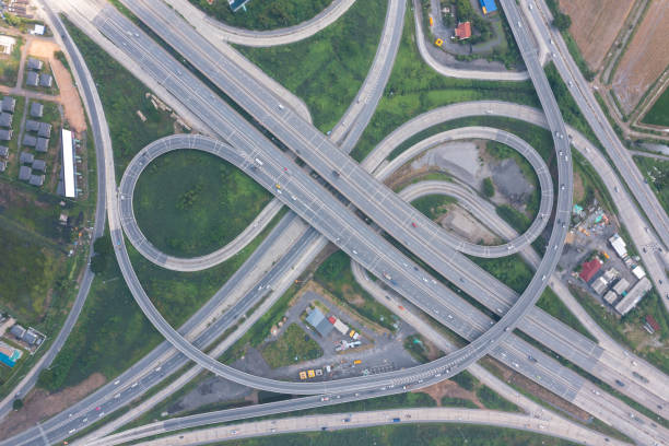 istock Aerial view of highway junctions with roundabout. Bridge roads shape circle in structure of architecture and transportation concept. Top view. Urban city, Bangkok at sunset, Thailand. 1351417159