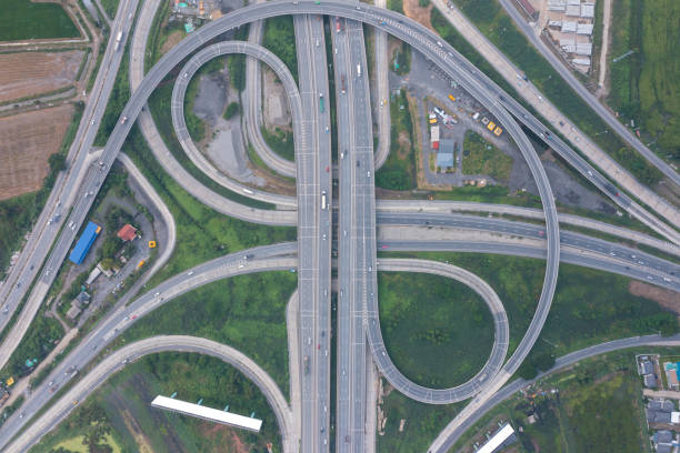 istock Aerial view of highway junctions with roundabout. Bridge roads shape circle in structure of architecture and transportation concept. Top view. Urban city, Bangkok at sunset, Thailand. 1351417160