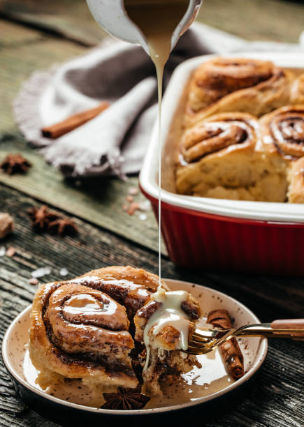 istock Cinnabon. Cinnamon rolls on a plate on a wooden table. top view 1351417270