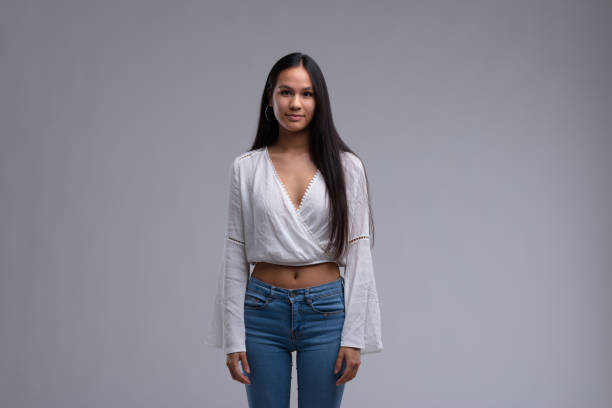istock Attractive trendy young woman with bare midriff 1351417411