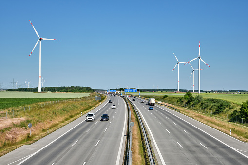 German motorway with wind turbines on a sunny day