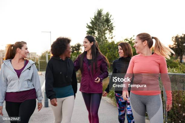 A Group Of Women Walking And Talking After Doing Some Outdoor Exercise Stock Photo - Download Image Now