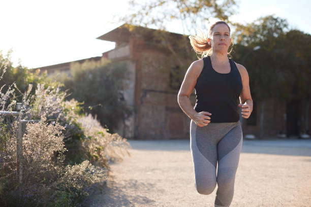 istock A woman running in a park at sunset. 1351421711