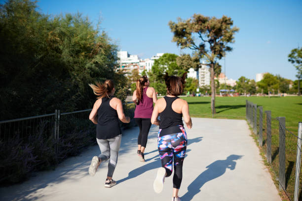 istock Three women running outdoors in Barcelona. 1351422373