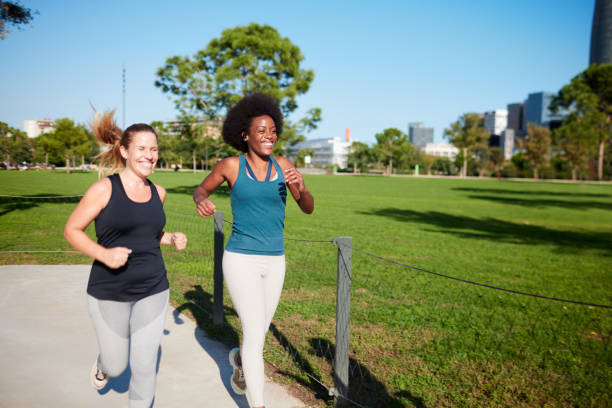 istock Two women jogging and exercising outdoors. 1351422377