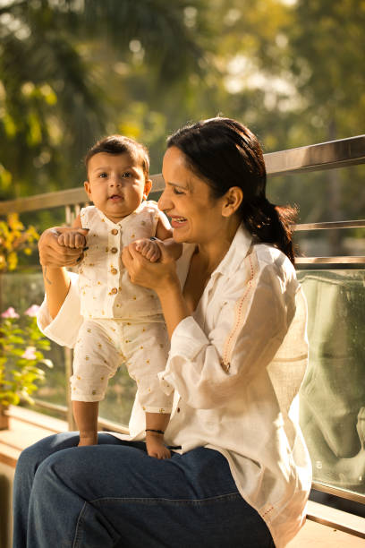 istock Mother playing with her baby boy in balcony 1351423699