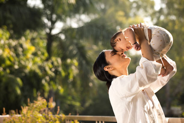 istock Young woman playing with her baby son 1351423735
