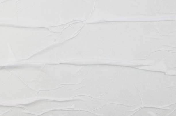 istock Blank white crumpled and creased sticker paper poster texture 1351425231