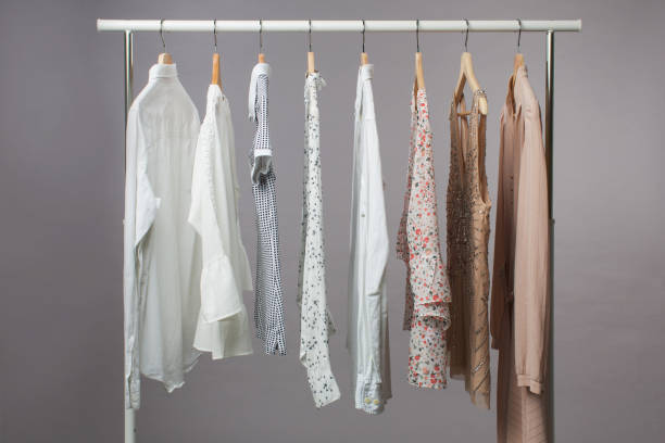 istock Woman's clothes in pastel colours hanging on rail 1351426415