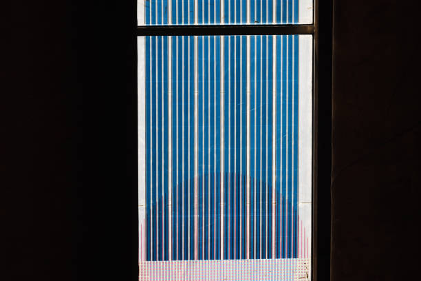 Close-up on silicon wafers on solar panels in a vertical row on black background