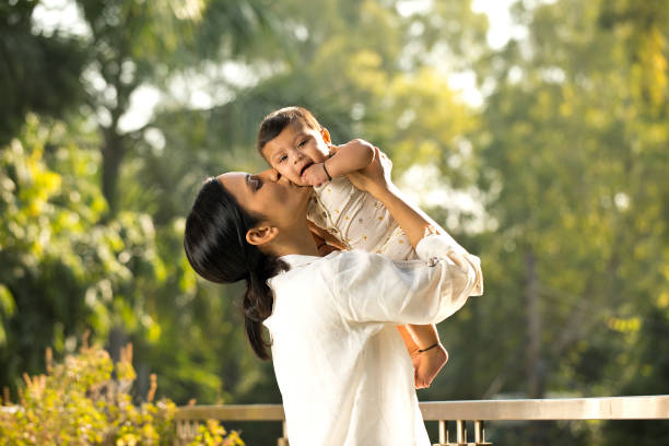 istock Young woman playing with her baby son 1351427626