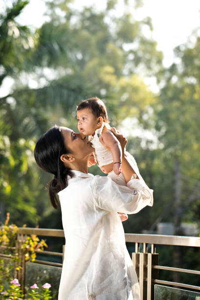 Young woman playing with her baby son