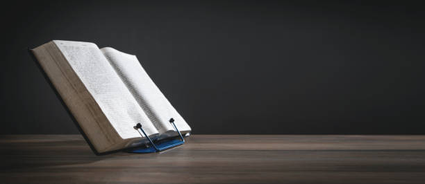istock Holy Bible on the wooden table. 1351428485