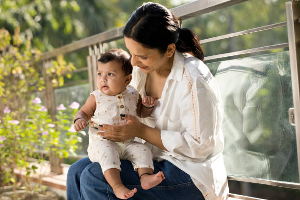 istock Mother playing with her baby boy in balcony 1351429661