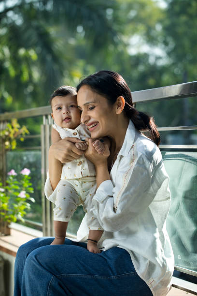 istock Mother playing with her baby boy in balcony 1351429743