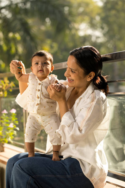 istock Mother playing with her baby boy in balcony 1351429763
