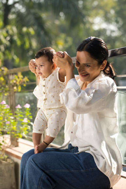 istock Mother playing with her baby boy in balcony 1351429768