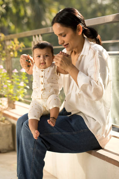 istock Mother playing with her baby boy in balcony 1351429784
