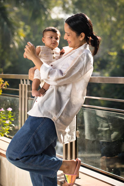 istock Mother playing with her baby boy in balcony 1351429797
