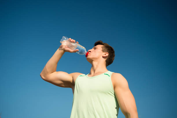istock Athlete in green tshirt on blue sky 1351430557