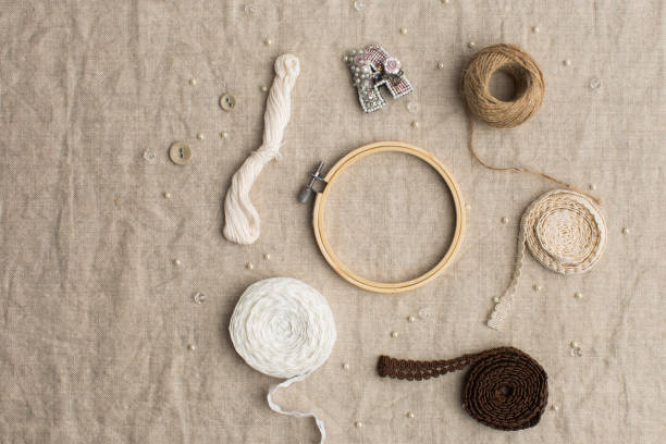 istock Handy craft concept, lace, braid, hoops on canvas texture 1351430615