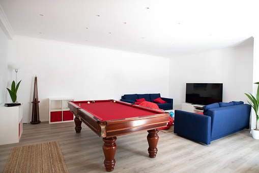 living room with pool table and blue sofas