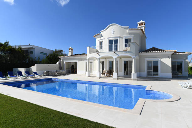 Exterior of luxury Holiday Villa Exterior of luxury Holiday Villa with blue sky and beautiful swimming pool airbnb stock pictures, royalty-free photos & images