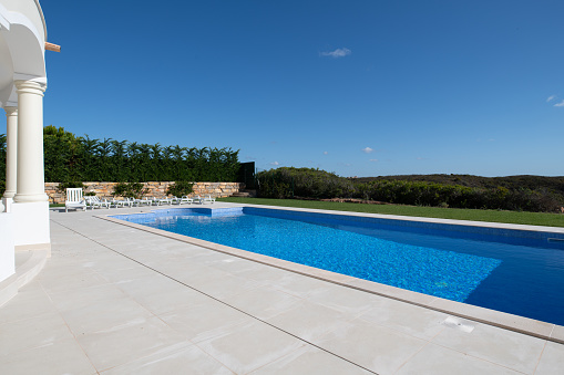 Garden And Swimming Pool Of The Modern House On A Sunny Day