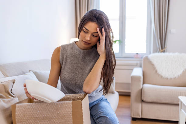 istock Disappointed shocked frustrated woman customer open cardboard box receive damaged wrong parcel 1351432530