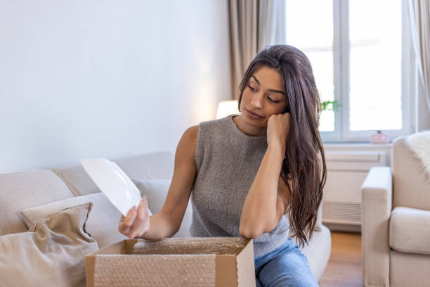 istock Disappointed shocked frustrated woman customer open cardboard box receive damaged wrong parcel 1351432531