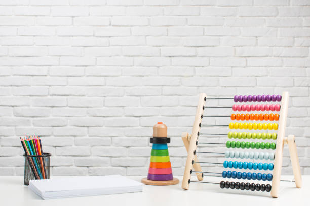 istock Toddler toys on white brick wall background 1351432779