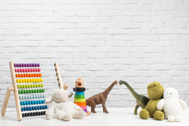 istock Toddler toys on white brick wall background 1351432786