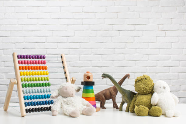 istock Toddler toys on white brick wall background 1351432793