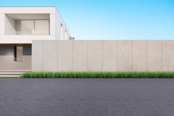 istock 3d rendering of modern house with wall and empty concrete road. 1351432968