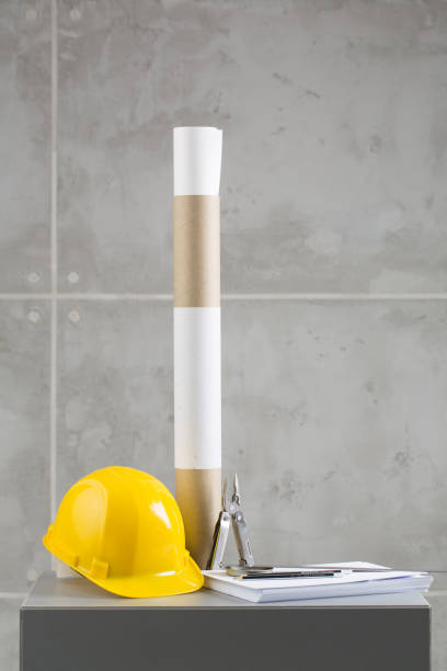 istock Yellow helmet, papers and pilers on concrete background 1351432984