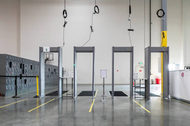 Metal Detectors in Fulfillment Center A line of four metal detectors at the entrance to a fulfillment center. metal detector security stock pictures, royalty-free photos & images