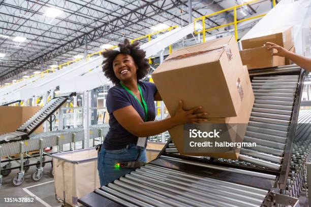 Cheerful Warehouse Employee Loading Boxes Into Truck Stock Photo - Download Image Now