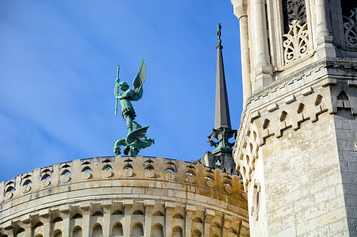 Archangel Saint Michael statue on the roofs of Basilica Notre Dame de Fourviere in Lyon, France