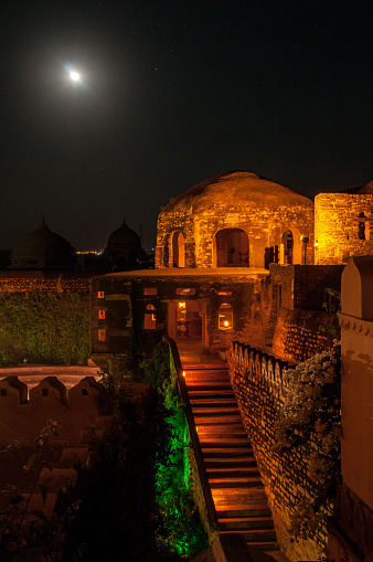 A magical atmosphere is created by the night lighting of the cupolas of the gazebos along the walls of the Khimsar Fort Hotel,