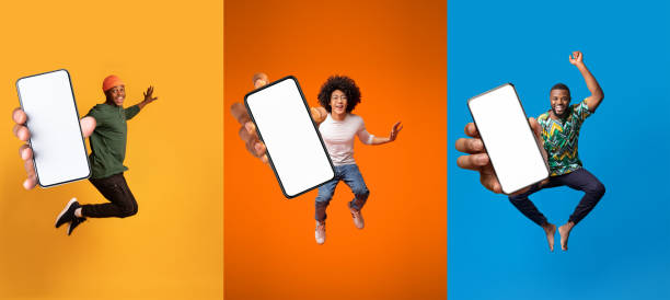 istock Joyful emotion excited millennial black men jumping and show device with blank screen, recommend website 1351438262