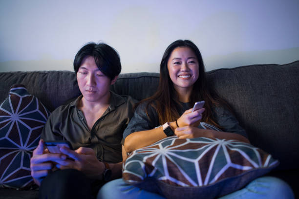 Couple watching TV with distracted Boyfriend stock photo