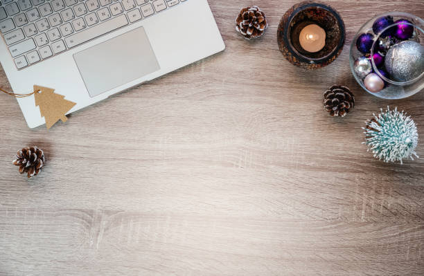 istock Christmas minimal creative background with laptop, Christmas decorations and notepad on the table 1351439261