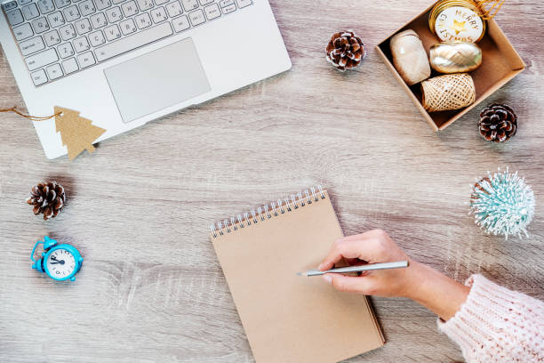 istock Christmas minimal creative background with laptop, Christmas decorations and notepad on the table 1351439299