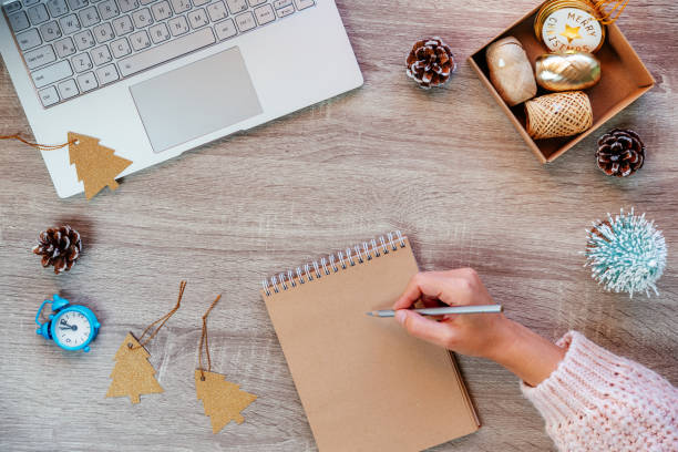 istock Christmas minimal creative background with laptop, Christmas decorations and notepad on the table 1351439333
