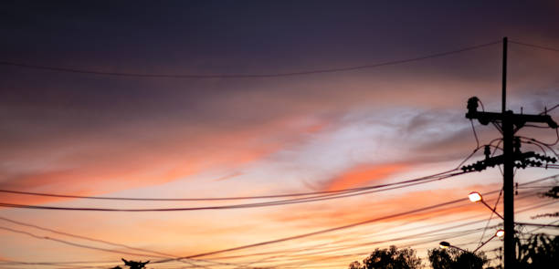 istock orange sky with electric poles sunset silhouette womtone 1351440381