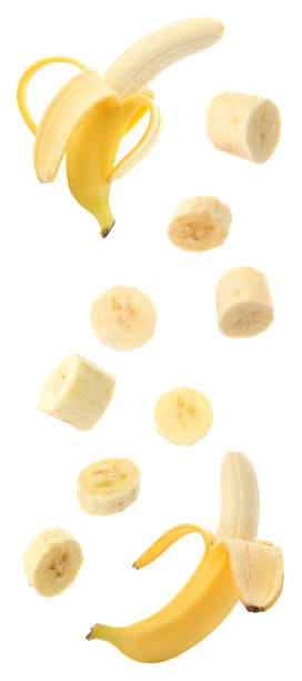 istock Set with delicious ripe bananas and pieces falling on white background 1351441413