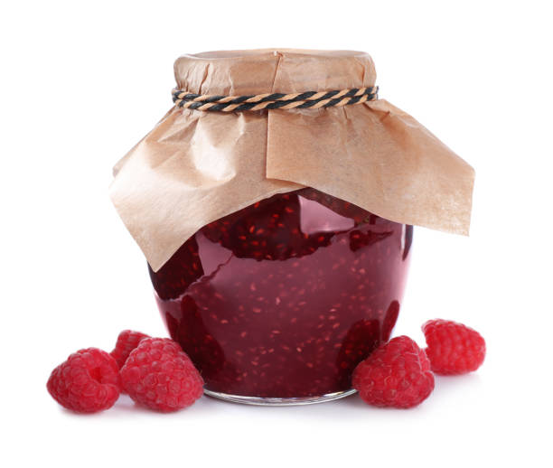 istock Delicious jam and fresh raspberries isolated on white 1351441613
