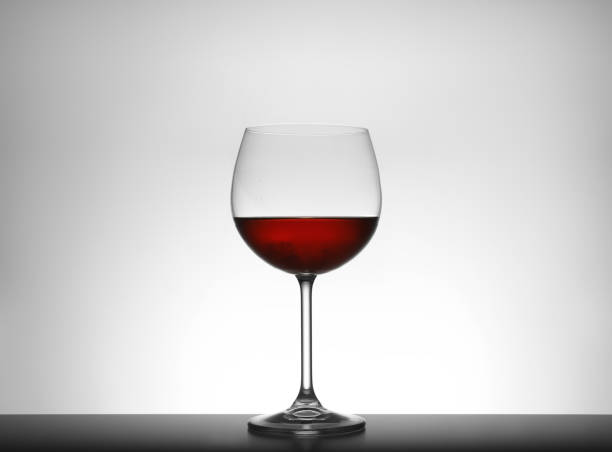 istock Glass of red wine isolated on white 1351442131